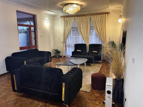 a living room with couches and a table at METRO Deluxe Specious Home in a Great Neighborhood!! in Addis Ababa