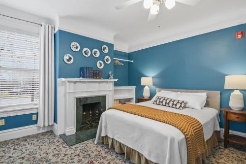 a blue bedroom with a bed and a fireplace at The Pasfield House in Springfield