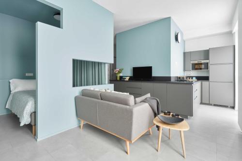 a living room with a couch and a table at UP to home - Residenze Milano in Milan