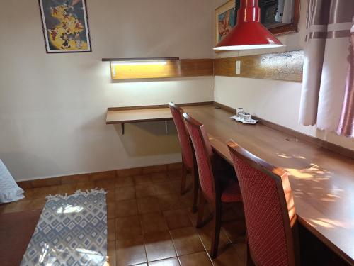 a dining room with a long wooden table and chairs at RESIDENCIA-UNIV in Ciudad del Este