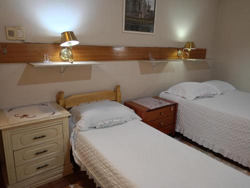 a bedroom with two beds and a dresser at RESIDENCIA-UNIV in Ciudad del Este