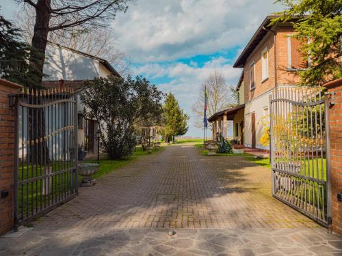 a cobblestone street in a residential neighborhood with a gate at B&B Villa Erika in Lugo