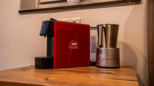 a red appliance sitting on top of a wooden table at Tiroler Alpblick Appartements in Ehrwald