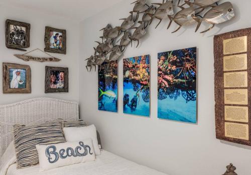 a bedroom with four pictures on the wall at The Pearl - Pool W Screen On Canal - Boat Rental in Cocoa Beach