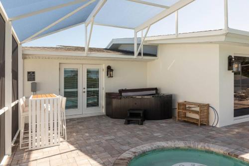 a patio with a swimming pool and a tent at The Pearl - Pool W Screen On Canal - Boat Rental in Cocoa Beach