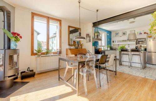 a dining room and kitchen with a table and chairs at repiton preneuf in Annecy