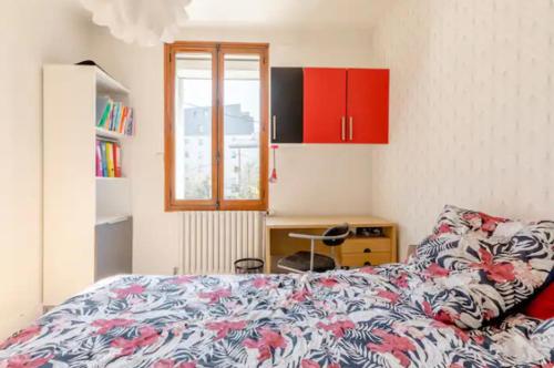 a bedroom with a bed and a desk and a window at repiton preneuf in Annecy