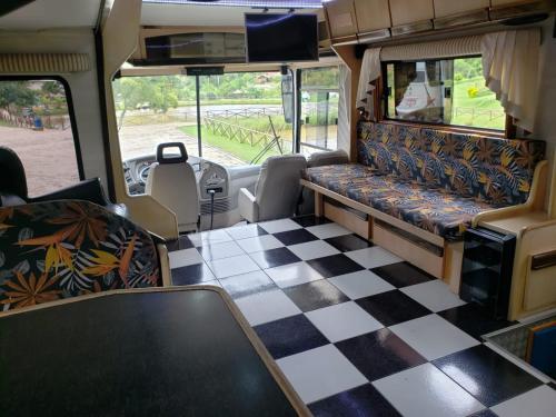 an empty bus with a checkered floor at Experiência num Luxuoso Motorhome in São Roque