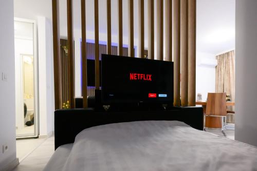 a bedroom with a bed with a television on it at Charming Hideaway Inspired by El Profesor's Intrigue in Bucharest