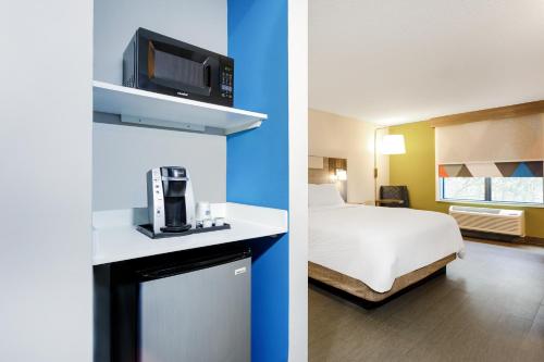 two pictures of a hotel room with a bed and a room with a bed sqor at Holiday Inn Express & Suites Jacksonville - Atlantic Beach by IHG in Jacksonville