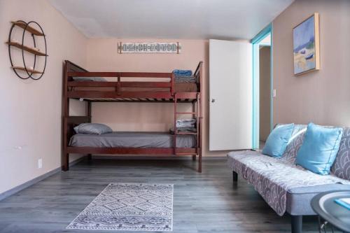 a room with two bunk beds and a couch at Be steps away from the beach - Downtown Rosarito in Rosarito