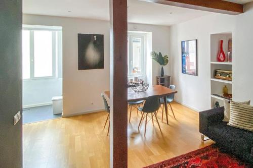 a living room with a table and a dining room at Lisbon deluxe city center flat in Lisbon