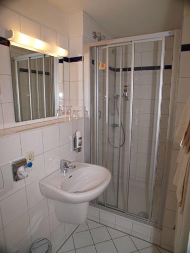 a bathroom with a shower and a sink at Gasthof Kampenwand Aschau in Aschau im Chiemgau