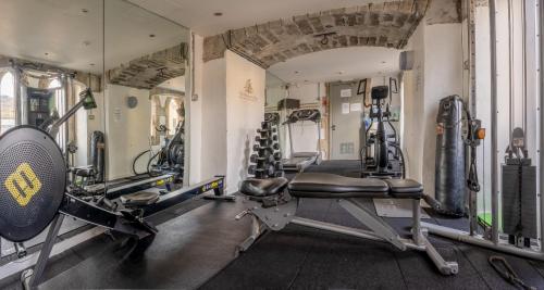 a gym with several tread machines in a room at Monastery apartment with Loch Ness view in Fort Augustus