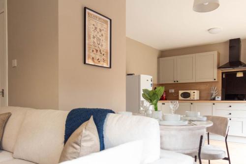 a living room with a white couch and a table at Grove House in North Queensferry