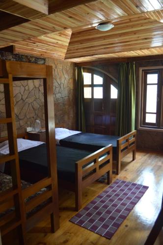 a bedroom with two bunk beds and a table at Quinton Enclave in Shillong