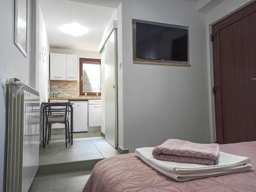 a bedroom with a bed with a tv on the wall at Soba Ulika in Motovun