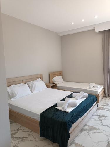 a bedroom with two beds with towels on them at Bella Kaliva in Kalives Poligirou