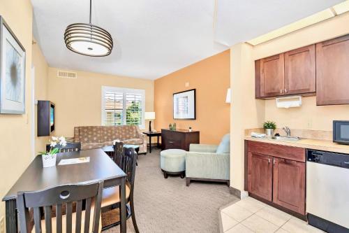 a living room with a kitchen and a dining room at Condo Close to Universal Studios - Pool Hot Tub in Orlando