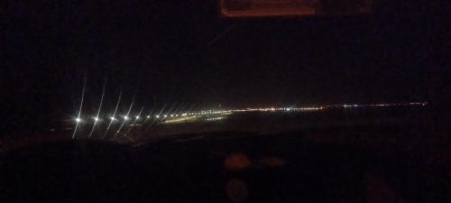 vista di una città di notte con luci di Hergla Sea view apartment & room a Harqalah