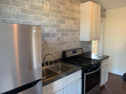 a kitchen with a sink and a stove at The Suites on Foundry in Morgantown