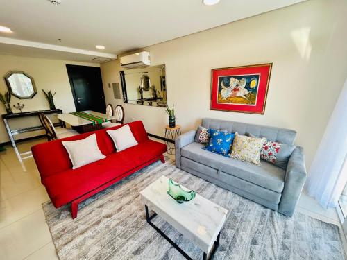 a living room with a red couch and a table at Viel Comfort Home in Asuncion