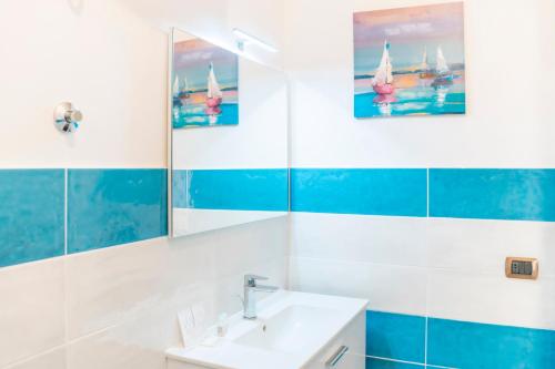 a bathroom with a sink and a mirror at Piazza Tasso Suite in Sorrento