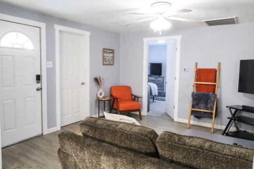 a living room with a couch and a tv at The Main Nest - Near City Center in Klamath Falls