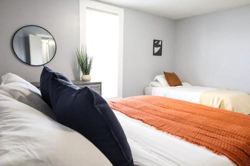 a bedroom with two beds and a mirror at The Main Nest - Near City Center in Klamath Falls