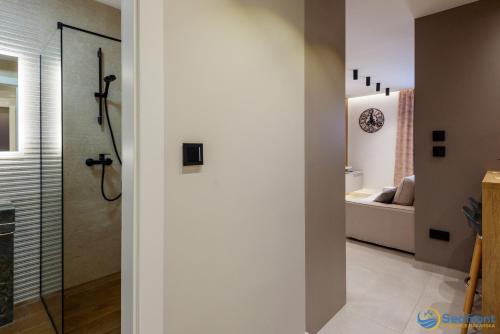 a bathroom with a shower and a toilet in a room at Seafront Residence Makarska in Makarska