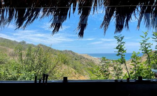 a view of the ocean from a house window at La Cabaña de Iza in Canoas