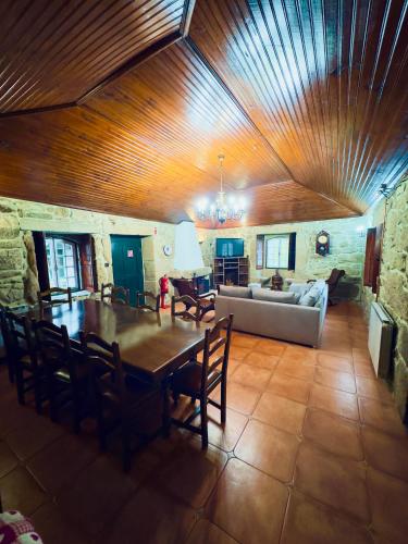 a living room with a table and a couch at QUINTA DONA MANUELA in Formariz