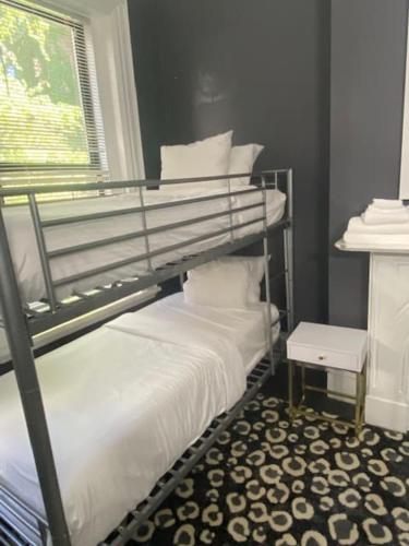 a bedroom with a bunk bed and a window at Premier Suites Bay Village in Boston