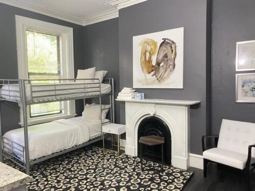 a room with two bunk beds and a fireplace at Premier Suites Bay Village in Boston