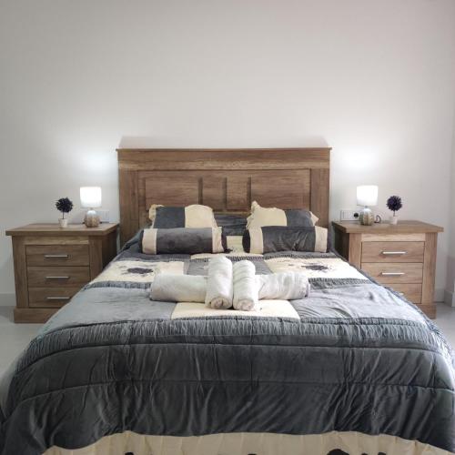 a bedroom with a large bed with towels on it at Apartamentos Costa in Los Alcázares