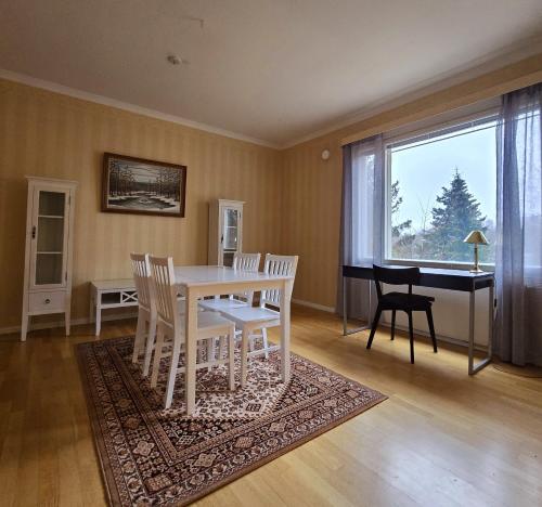 a dining room with a table and chairs and a piano at Rauma Room's House 9 200m2 in Rauma
