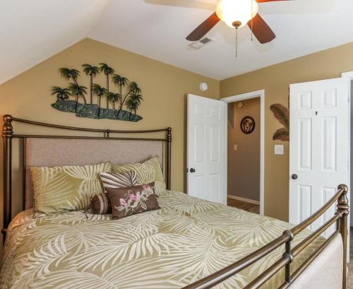 a bedroom with a bed with palm trees on the wall at House# 60 Point of View (pet friendly) in Centre