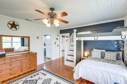 a bedroom with a bed and a ceiling fan at Texas Farmhouse on 14 Acres with Pond Access! 
