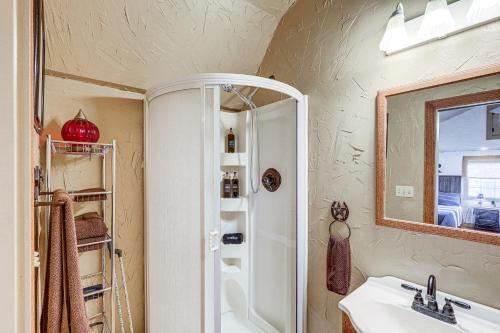 a bathroom with a shower and a sink and a mirror at Texas Farmhouse on 14 Acres with Pond Access! 