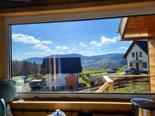 a window with a view of a barn and mountains at Dream Catcher House 