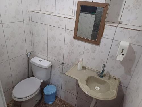 a small bathroom with a toilet and a sink at Pousada Mara Mar Niterói in Niterói