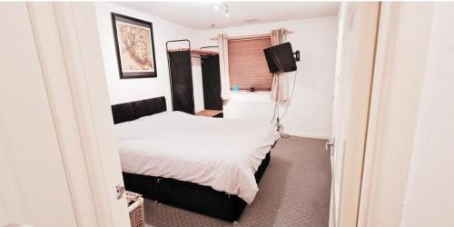 a bedroom with a bed and a television in it at 1 Bed Terrace House near Mapperley in Nottingham