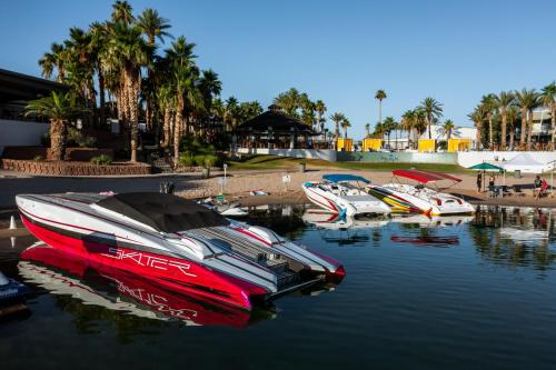 a group of boats are docked in the water at The Nautical Beachfront Resort in Lake Havasu City