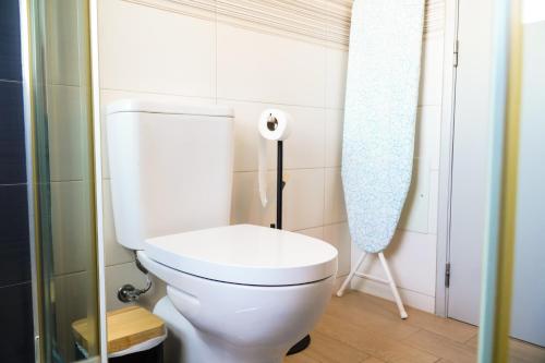 a bathroom with a toilet and a roll of toilet paper at Villa Marrachinho in Albufeira