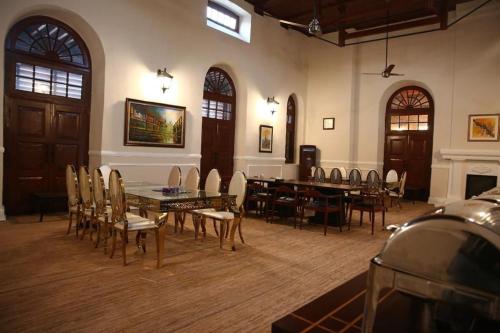 a dining room with a table and chairs in it at Peshawar Barracks by Shelton's Rezidor in Peshawar