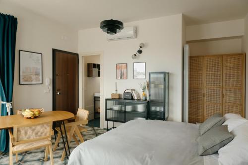 a bedroom with a bed and a table and a desk at La Bella Vita Lecce in Lecce