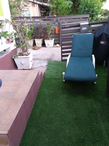 a chair sitting on the grass in a yard at Lendal APT in Saint James