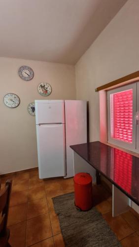 a kitchen with a white refrigerator and a table at Herdade do Redondo in Escalos de Baixo