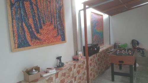 a room with a table and a painting on the wall at Colores Hospedaje Miraflores in Lima