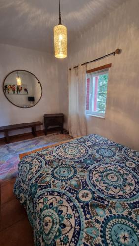 a bedroom with a large bed with a large mirror at Herdade do Redondo in Escalos de Baixo